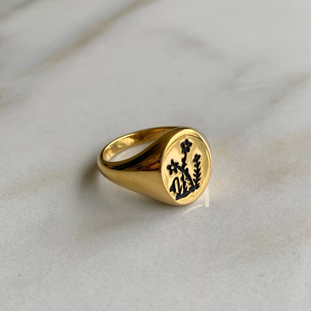 Silver signet ring photographed against a plain background for a marketplace listing